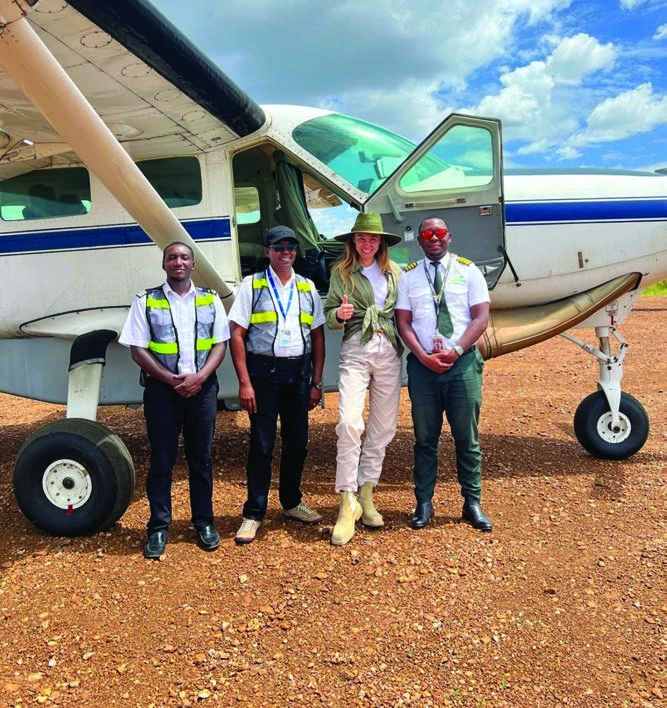 Aviation personnel standing beside an aircraft